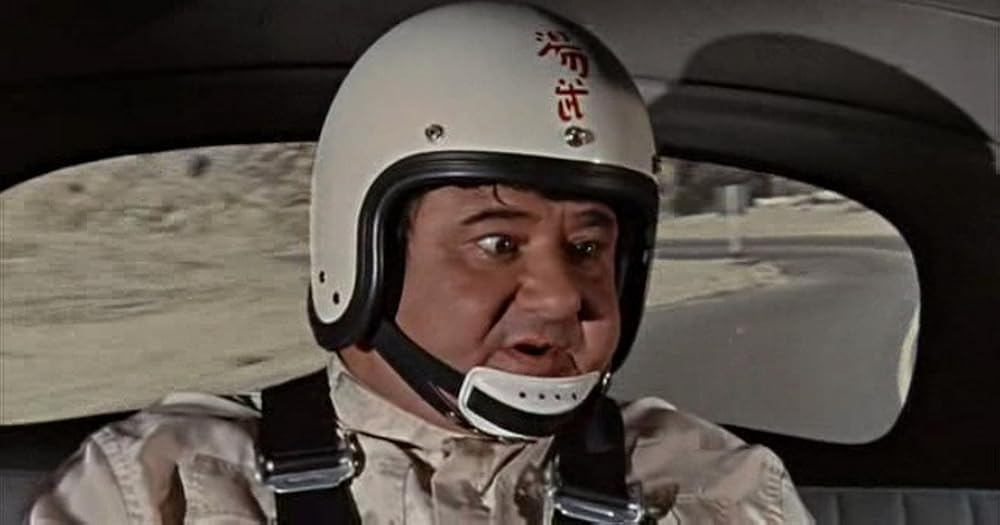 Buddy Hackett wearing a helmet with a chin strap
